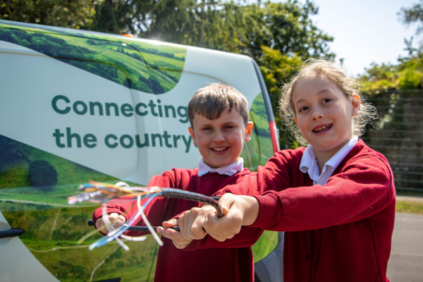 Two pupils in front of Wessex Internet van