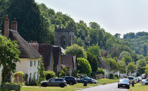 Milton Abbas high street including church and cars