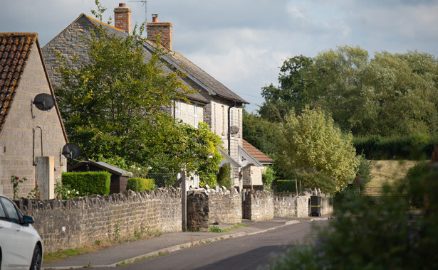 Long Sutton property with stone wall and trees