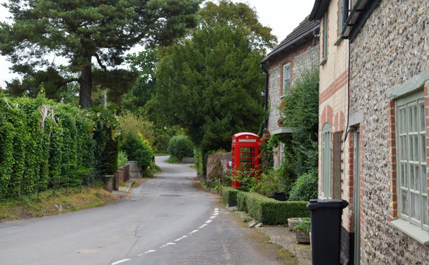 Red telephone box off of a main road