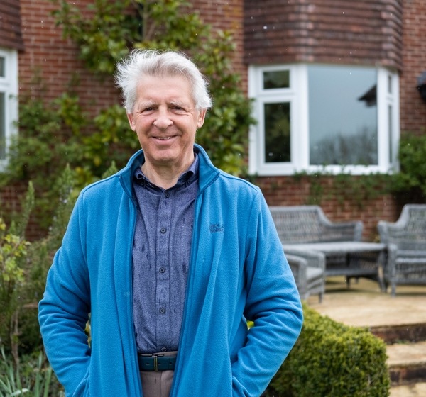 Alastair Fisher in the garden in front of property