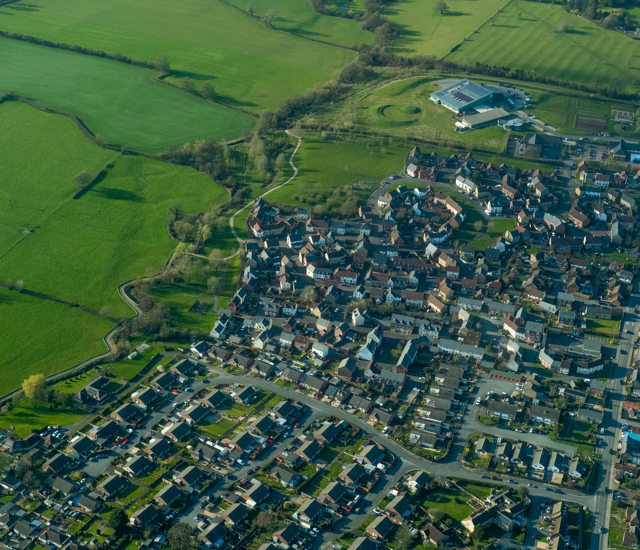 Aerial view of green fields and houses