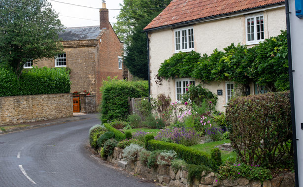 Cottage with front garden off a main road